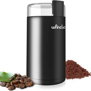 Electric coffee grinder with coffee beans and grounds.